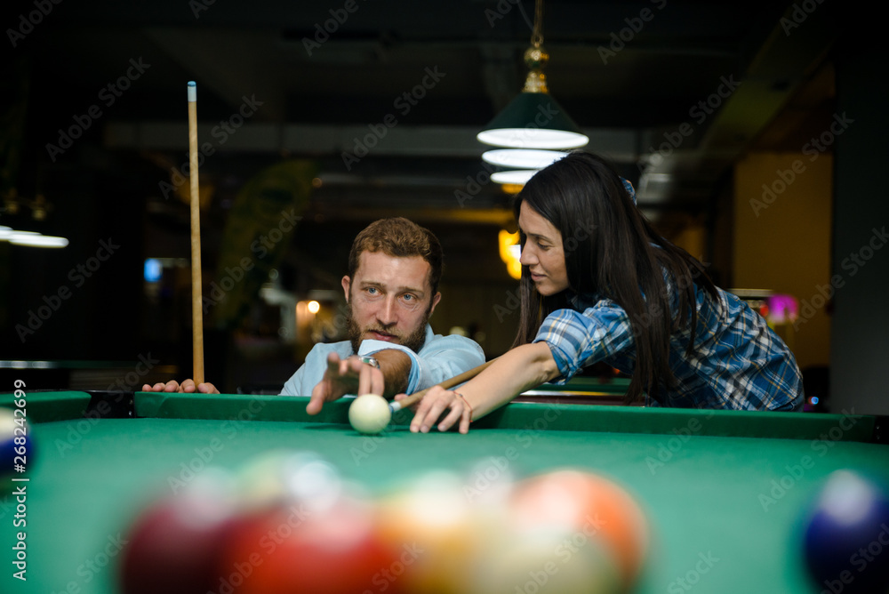 Fototapeta premium Happy couple playing snooker together