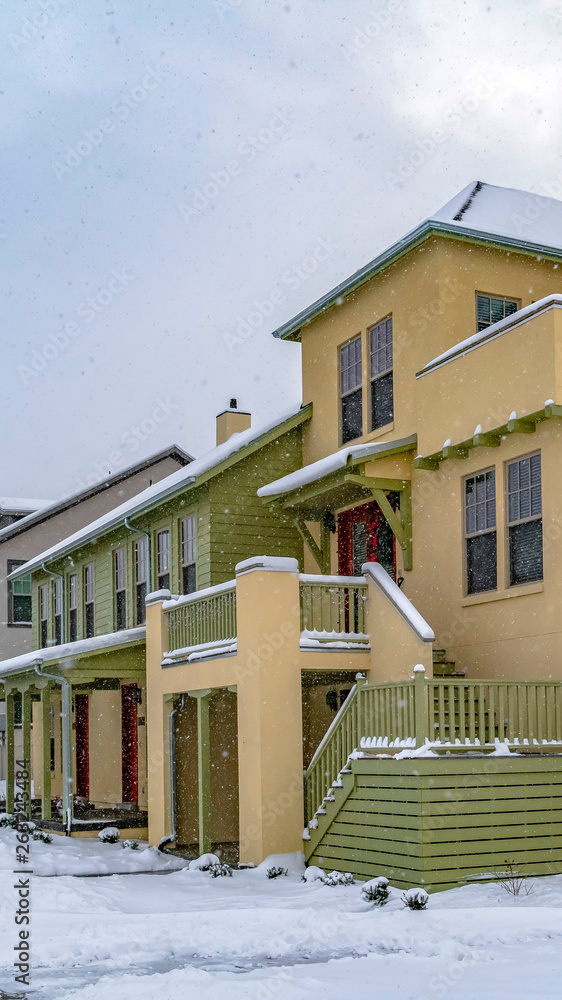 Clear Vertical Wet and snowy pathway in front of adorable homes in Daybreak Utah