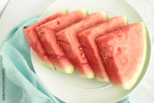 on a white ceramic plate are slices juicy, beautiful watermelon