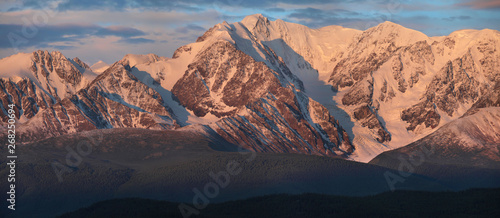 Panoramic mountain view, hiking in the mountains. Dawn light on the tops. Traveling in Russia, Altay.