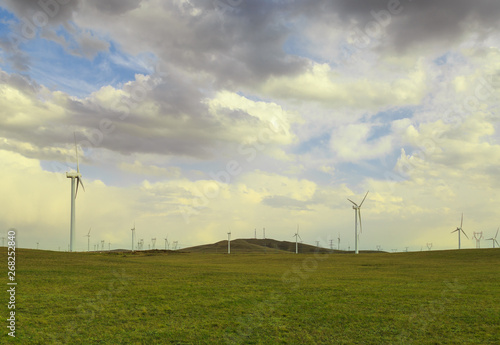 A windmill that generates electricity on the prairie