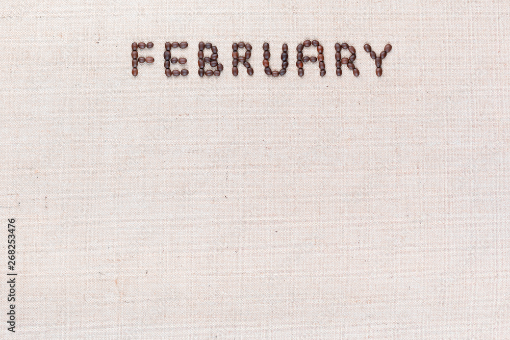 The word February written with coffee beans shot from above, aligned at the top.