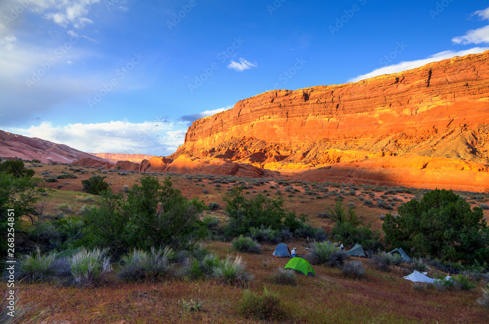 A group of backpackers camps in the Waterpocket Fold along Halls Creek in Captiol Reef National Park. A group of backpackers camps in the Waterpocket Fold along Halls Creek in Captiol Reef National Park.