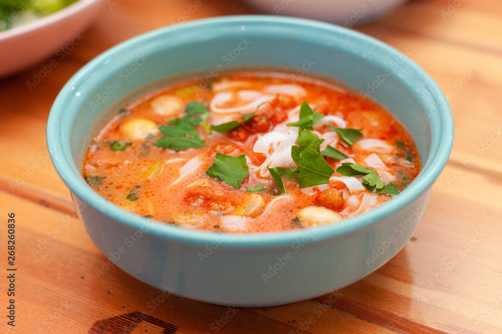 Vegetarian spicy soup with vegetable broth, mushrooms and ribbon noodles Vegetarian spicy soup with vegetable broth, mushrooms and ribbon noodles