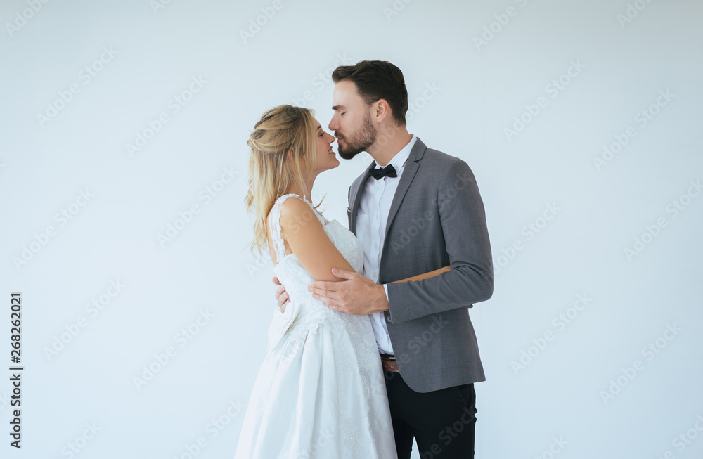 Picture of groom with bride romantic couple is kissing and hugging together on white background,Positive thinking in wedding day,Copy space for text