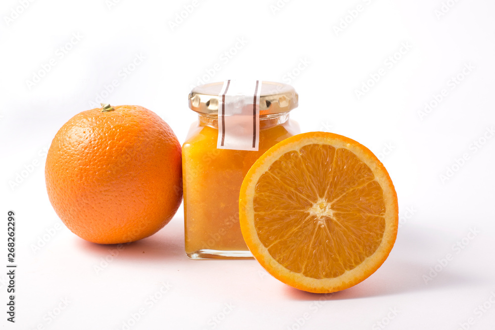 Glass jar with orange jam and orange on white background Glass jar with orange jam and orange on white background