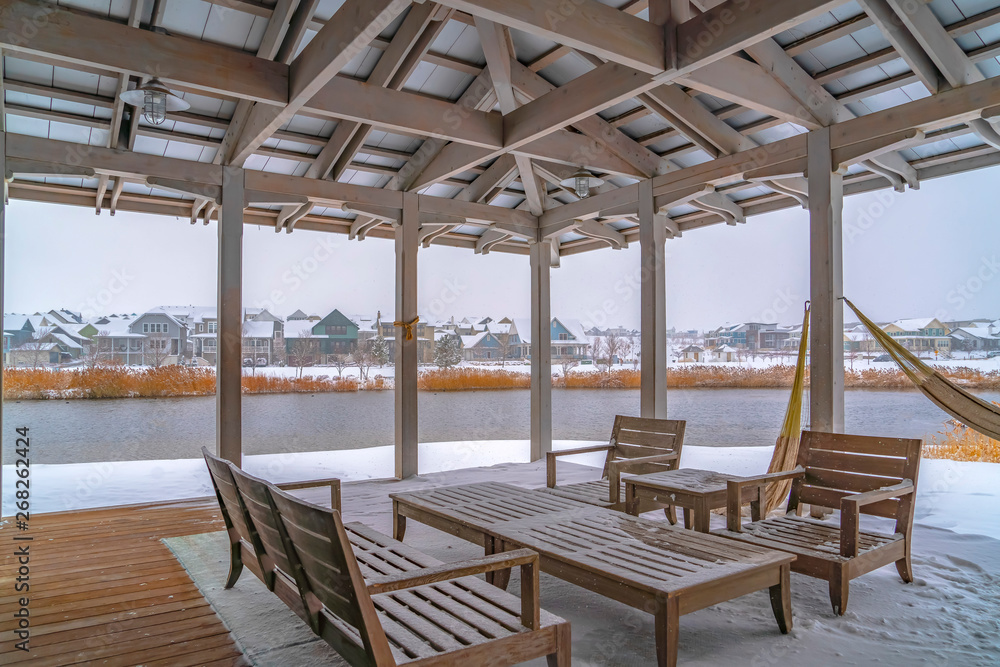 Snowy patio of a clubhouse overlooking Oquirh Lake