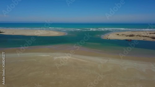 Aerial tracking shot where the Murray River meets the Southern Ocean in Goolwa, South Australia.Dredge can be seen at the Murray Mouth. photo