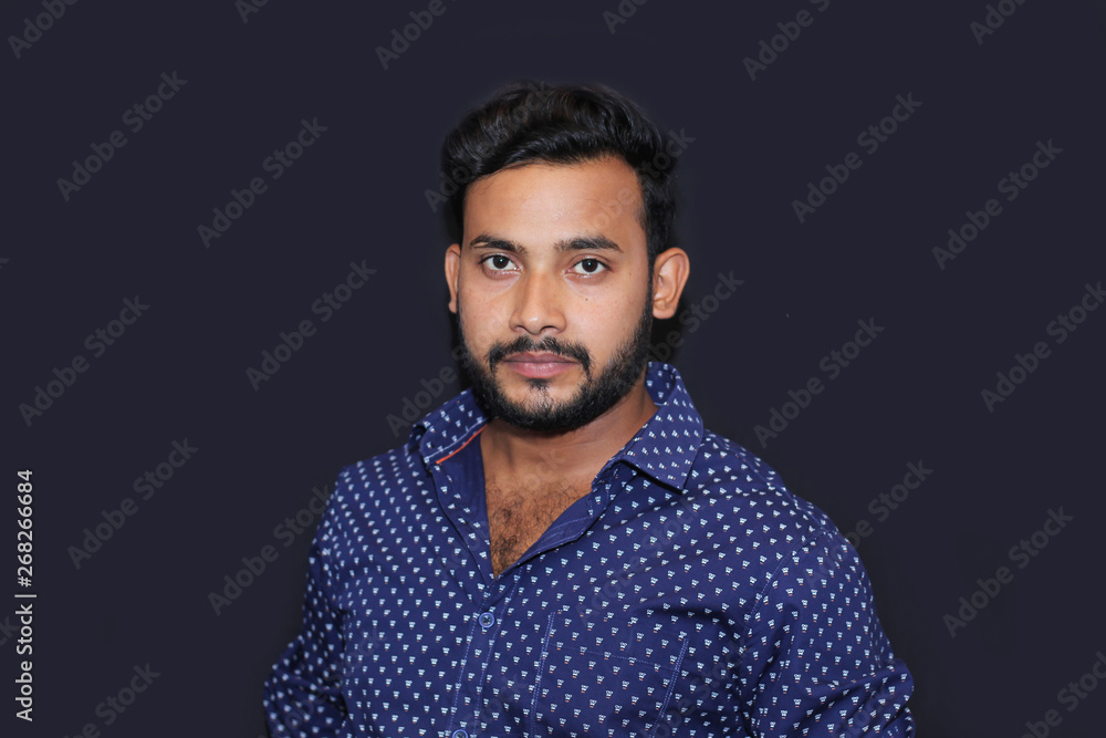 Fototapeta premium portrait of a young man model with black background front view