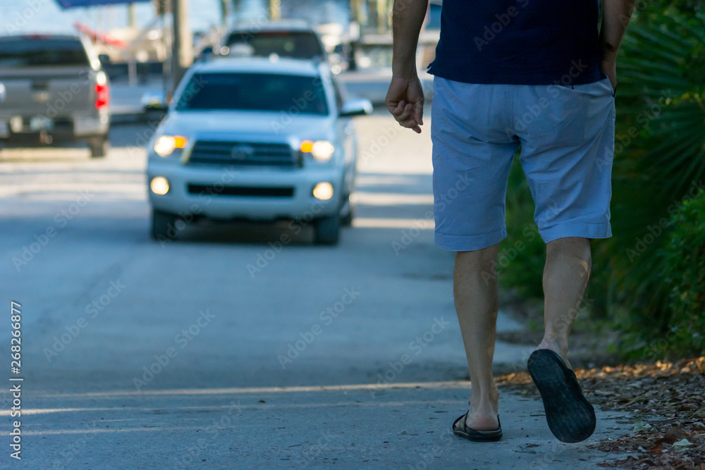 Man Walking on the Street on Blur Car Background. Destin Beach, Florida