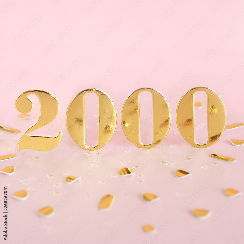 The number 2000 in golden numbers on a pink background and golden