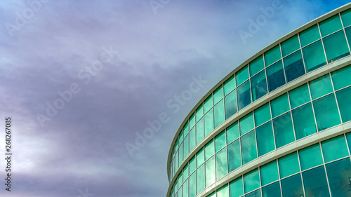 Panorama Exterior view of a modern office building with reflective glass wall