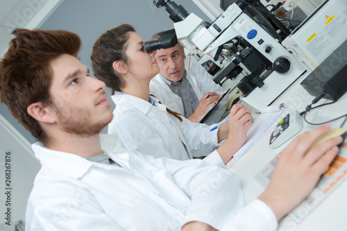medical students working with microscope at the university