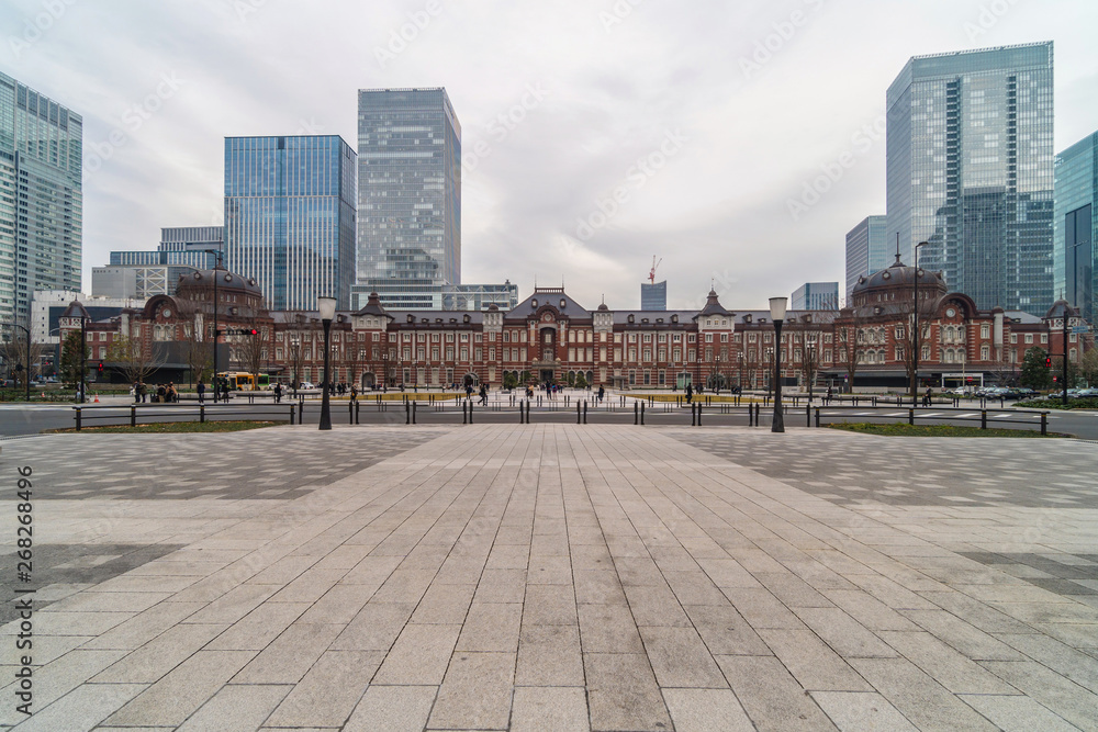 TOKYO, JAPAN - FEB 2019 : Crowd Undefined people visiting and enjoying at Tokyo Station and Marunouchi with car traffic Tokyo city on Febuary 19, 2019, building architecture and landmark concept