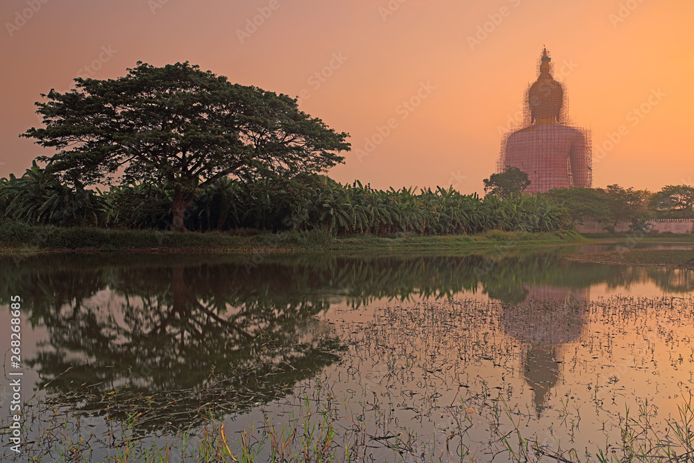 Obraz premium Beautiful view of big golden buddha at Wat Muang in during sunrise, Ang Thong province, Thailand 