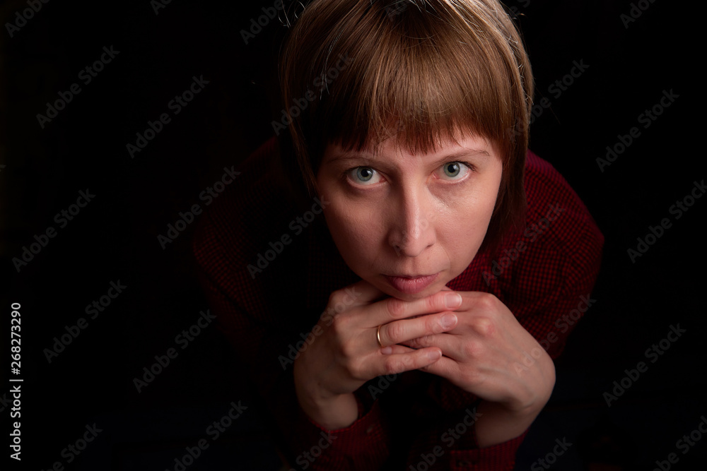 Portrait of ugly but sweet girl with chubby cheeks and black background Portrait of ugly but sweet girl with chubby cheeks and black background