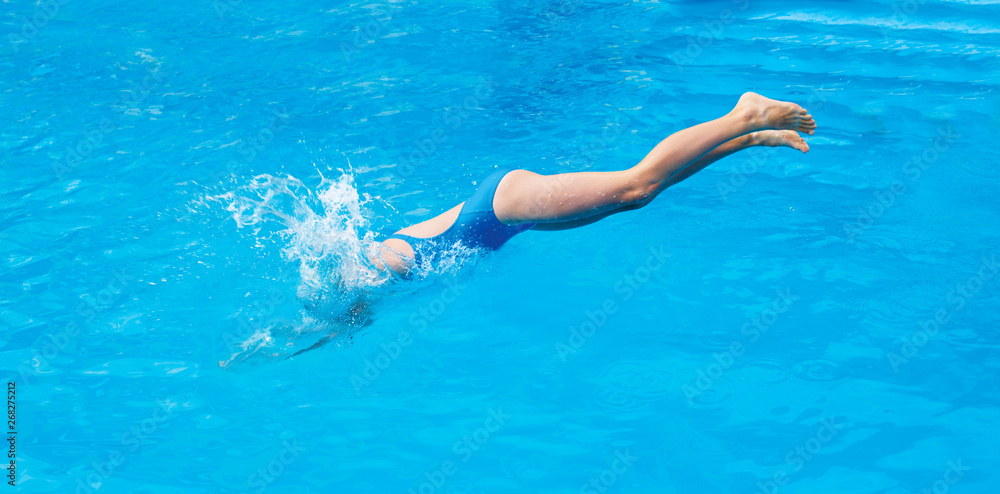 Child jump in the swimming pool. Summer sport time
