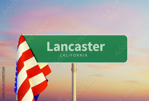 Lancaster – California. Road or Town Sign. Flag of the united states. Sunset oder Sunrise Sky photo