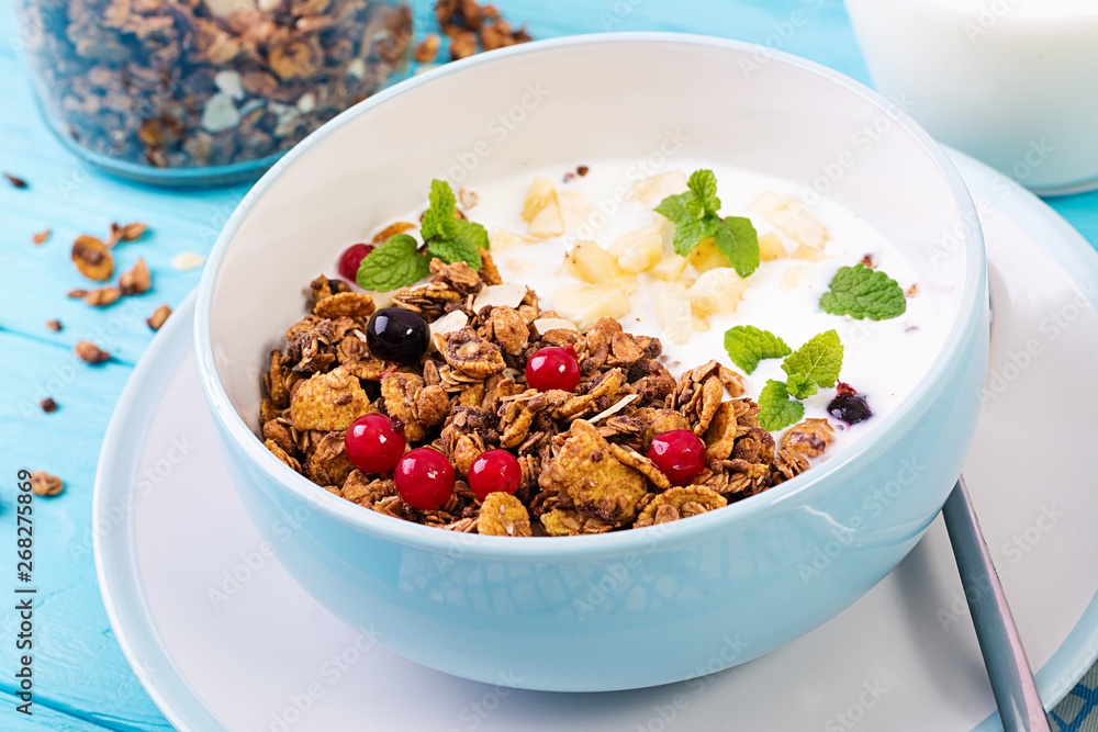Breakfast. Bowl of homemade granola with yogurt and fresh berries. Table setting. Healthy food. Breakfast. Bowl of homemade granola with yogurt and fresh berries. Table setting. Healthy food.