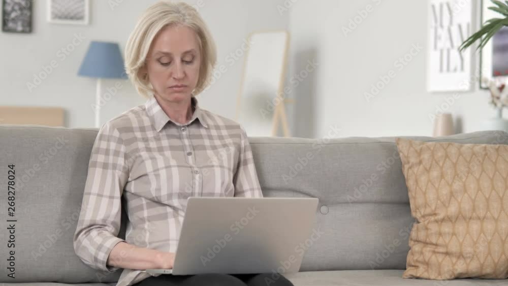 Old Woman Thinking and Working on Laptop Old Woman Thinking and Working on Laptop