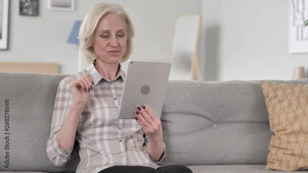 Online Video Chat by Aged Woman on Tablet Online Video Chat by Aged Woman on Tablet