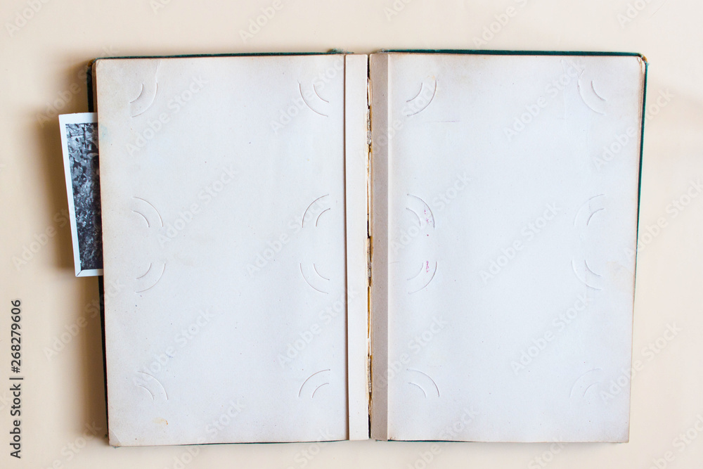Old photo album with open page with frames and photos. Top view. Old photo album with open page with frames and photos. Top view.