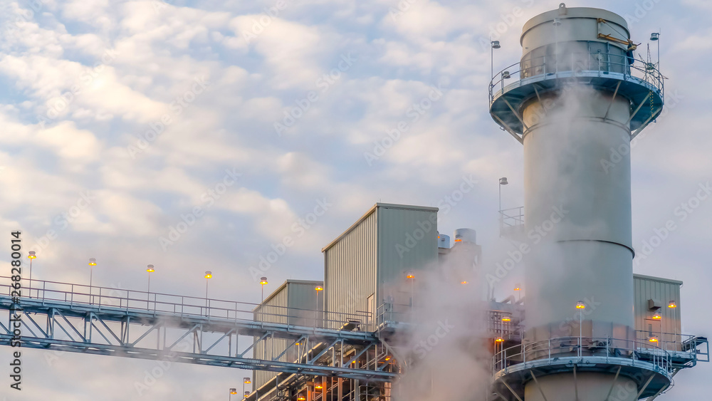 Obraz premium Clear Panorama Steam emitted from a Power Plant in Utah Valley against cloudy blue sky