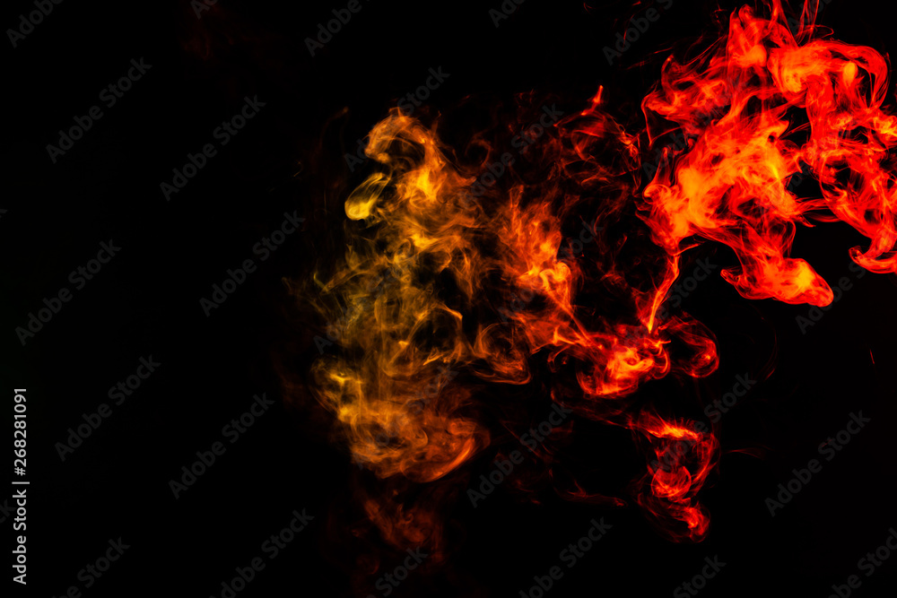 Beautiful horizontal column of smoke in the neon bright light of red, green, yellow and orange on a black background exhaled out of the vape. Nice pattern for printing and backdrop of colored waves. Beautiful horizontal column of smoke in the neon bright light of red, green, yellow and orange on a black background exhaled out of the vape. Nice pattern for printing and backdrop of colored waves.