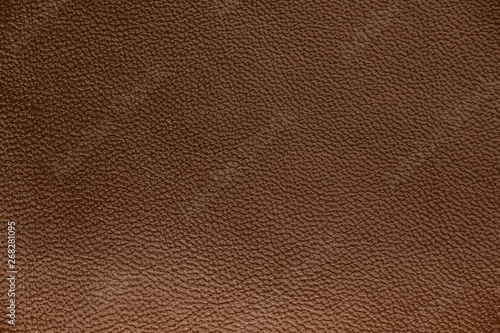 The texture of genuine leather. Impeccable and stylish background.  Beautiful stylish background. Natural skin texture close up. Brown background.  The structure of the leather material brown shades.