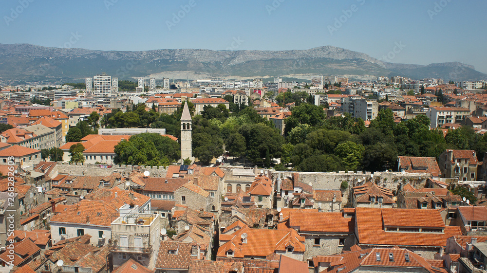 Scenic top view of the city from the bell tower, roofs of houses and church in old town, beautiful cityscape, sunny day, Split, Croatia