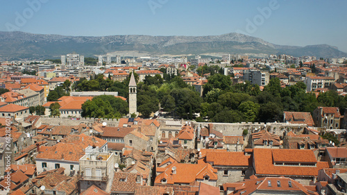 Scenic top view of the city from the bell tower, roofs of houses and church in old town, beautiful cityscape, sunny day, Split, Croatia