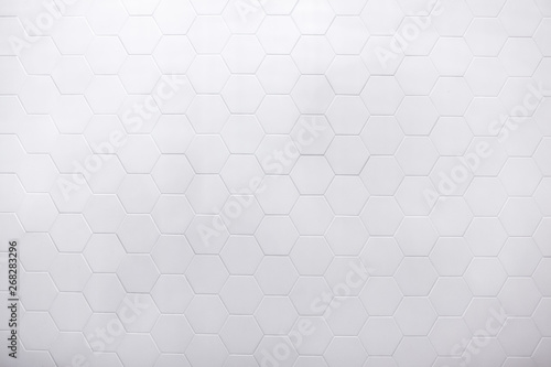 real photo of white hexagonal tiles wall of the bathroom