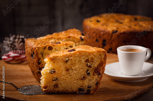 Slices of home made cake with raisins on wooden plate and coffee cup