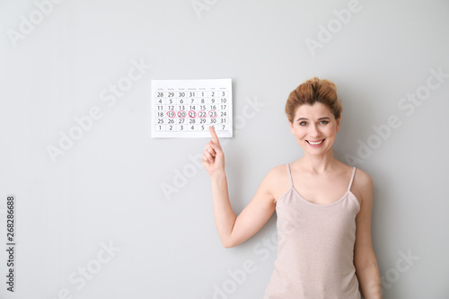 Happy woman with calendar o...