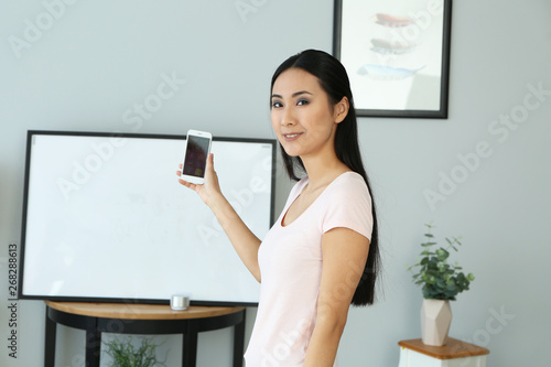 Young Asian woman using app...