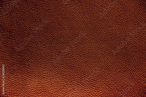The texture of genuine leather. Impeccable and stylish background. Beautiful stylish background. Natural skin texture close up. Brown background. The structure of the leather material brown shades.
