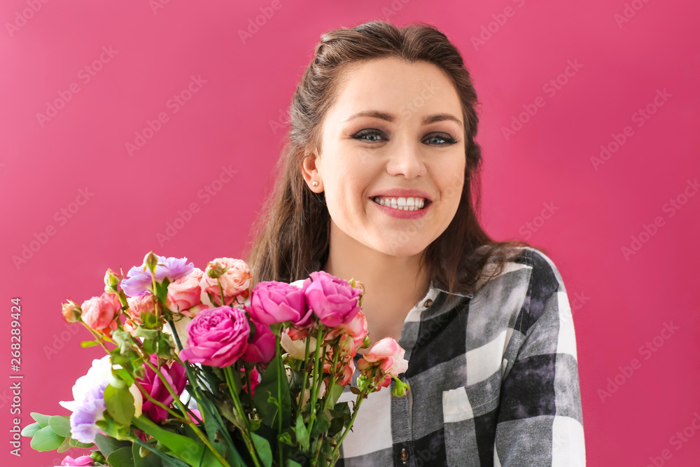 Beautiful young woman with bouquet of flowers on color background