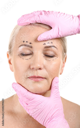 Plastic surgeon touching fa...
