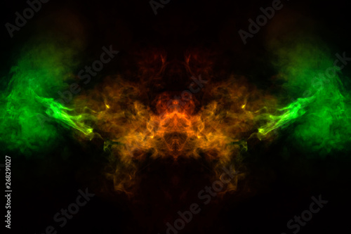 Abstract image of smoke of different green, yellow, orange and red colors in the form of horror in the shape of the head, face and eye on a black isolated background. Soul and ghost in mystical symbol © Aleksandr Kondratov