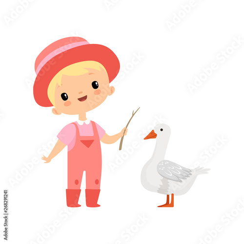 Cute Boy in Overalls, Rubber Boots and Hat Grazing Goose, Young Farmer Cartoon Character Engaged in Agricultural Activities Vector Illustration