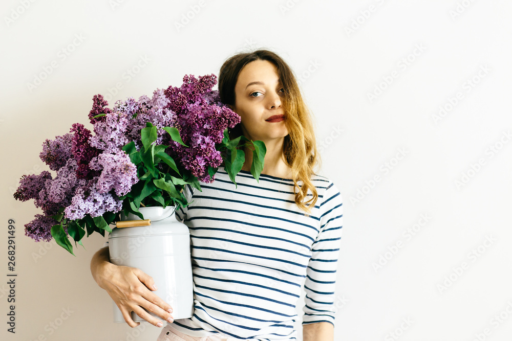 Pretty women with a purple bouquet of lilac on a white background Pretty women with a purple bouquet of lilac on a white background