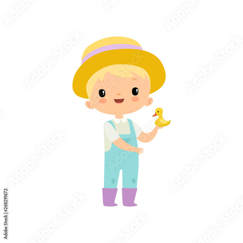 Cute Boy in Overalls, Rubber Boots and Hat Holding Duckling, Young Farmer Cartoon Character Engaged in Agricultural Activities Vector Illustration