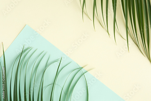 Tropical palm background. Creative layout made of green tropical leaves on bl...