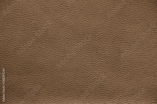 The texture of genuine leather. Impeccable and stylish background.  Beautiful stylish background. Natural skin texture close up. Brown background.  The structure of the leather material brown shades.