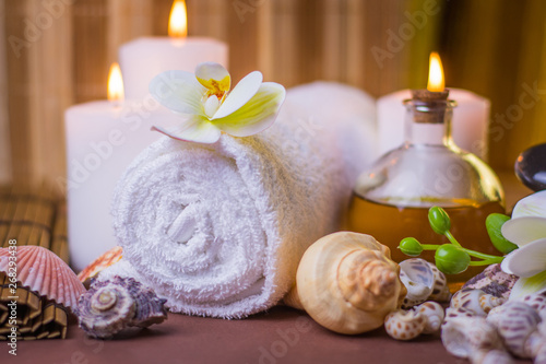 Massage spa treatment image relaxation background burning candles with flowers and seashells