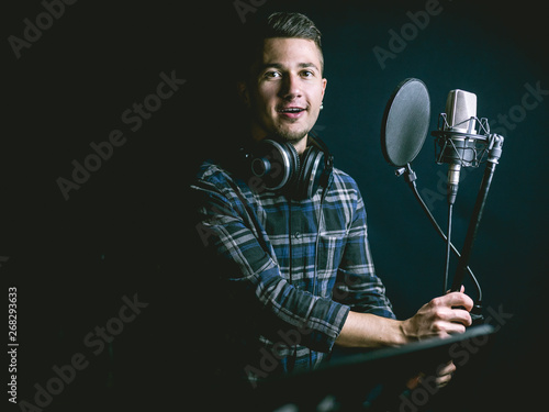 The young guy singing in recording studio