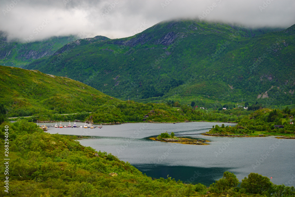 Fjord landscape with fishing boats in port