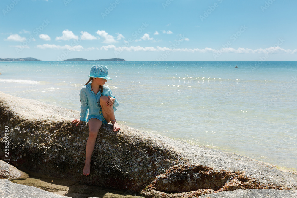 Cute teens girl in blue hat relax ocean background.