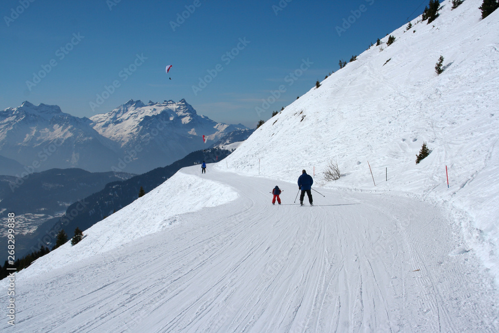 Ski, winter, snow - family enjoying winter vacation in Verbier, Switzerland