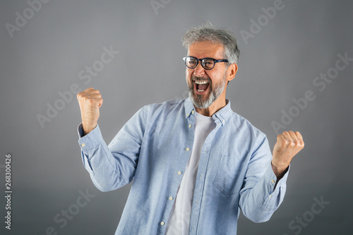 Obraz na płótnie happy middle aged man on gray background